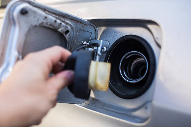 istock Gas cap with hand near fuel pump 492890554