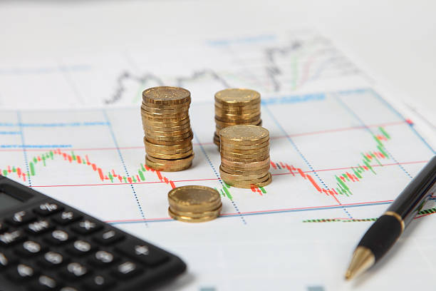 istock Calculator and stacks of coins 492890872