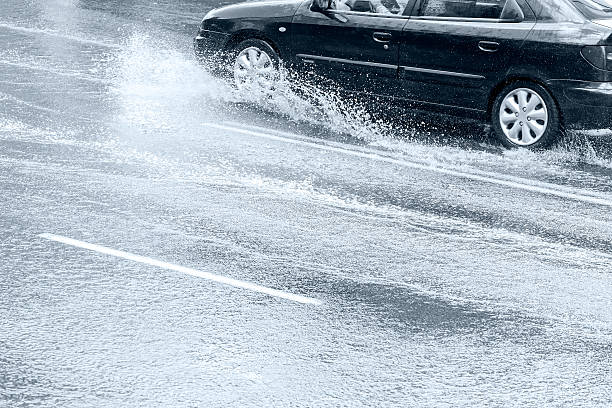 istock car riding on wet street 492891822