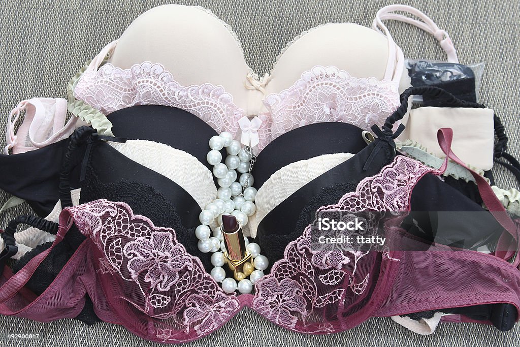 Sexy arm Bunch of sexy silk and lace lingerie bras Bra Stock Photo