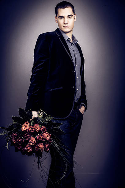 istock man holding bouquet of roses 492901837