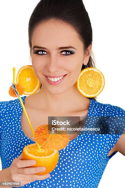 Girl With Orange Drink And Orange Slice Earrings White Background Stock Photo - Download Image Now