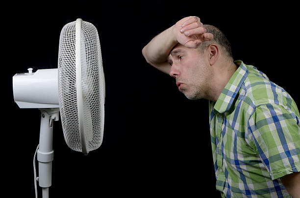 istock Man in front of a fan (2) 492902723