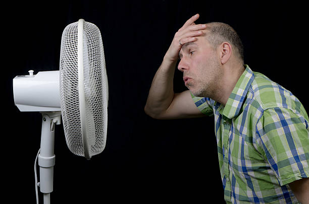 istock Man in front of a fan 492902891