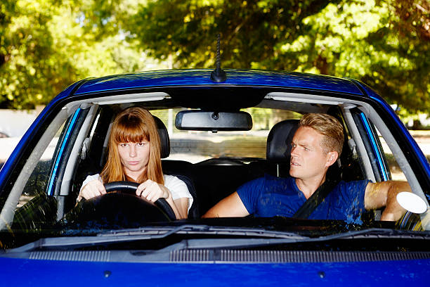 istock Arguing couple in car; she's driving, he's complaining 492903579