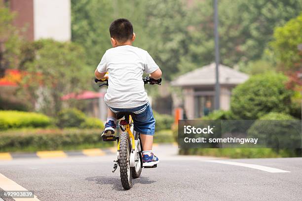 Schoolboy On A Bicycle Residential Area In A Quiet Stock Photo - Download Image Now - Child, Townhouse, 6-7 Years