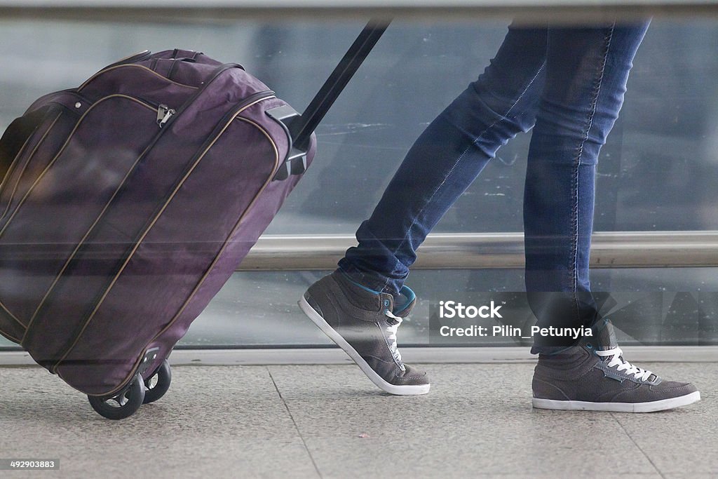 Woman carries your luggage at the airport terminal Woman carries your luggage at the airport terminal of Hong Kong Adult Stock Photo