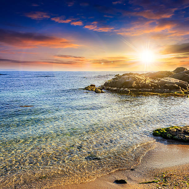 istock calm sea with waves on  sandy beach at sunset 492904289