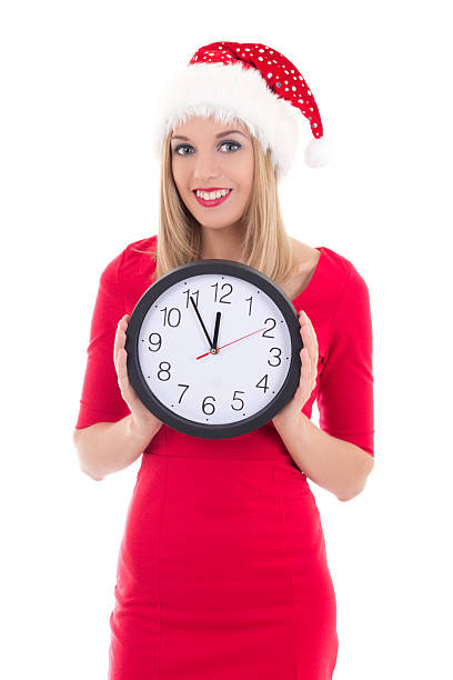 istock happy woman in santa hat with clock posing 492905170