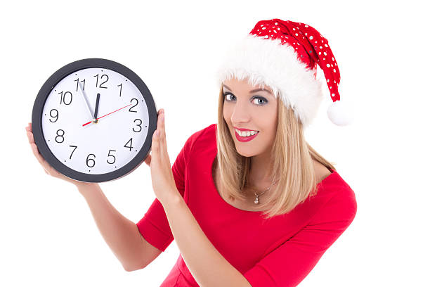 istock beautiful woman in santa hat with clock posing 492905246