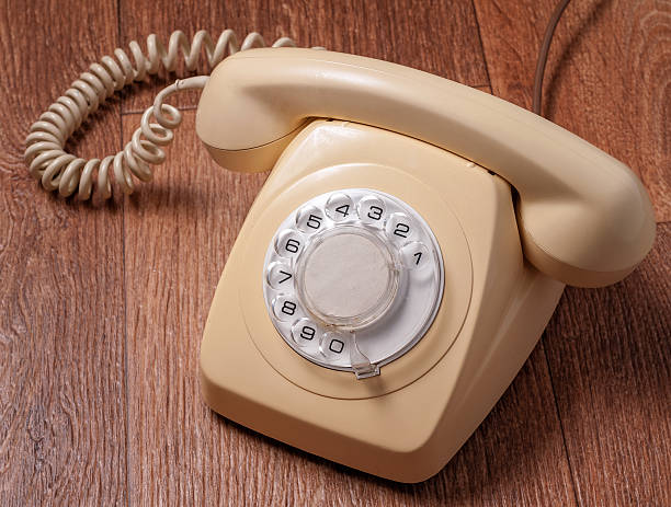 istock Retro telephone on wooden table in front gradient background 492905722