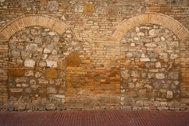Old stone and brick wall with infill, in Tuscany, Italy