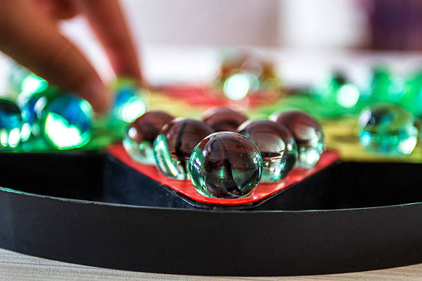 istock hand placing glass ball chess on the checker 492907314
