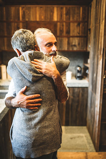 istock senior couple embracing passionate in the house - support concept 492908582