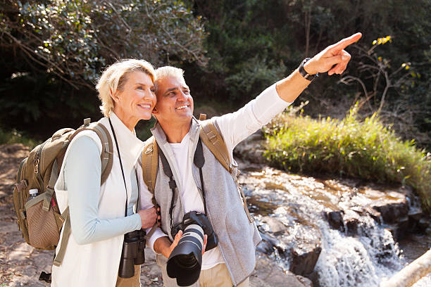 istock senior couple hikers in mountain valley 492910470