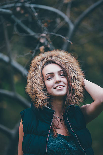 istock Young pretty girl standing near the tree. 492912358
