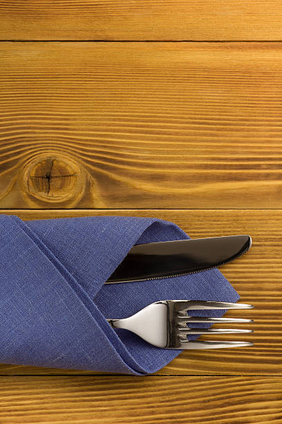 istock knife and fork at napkin on wood 492914064