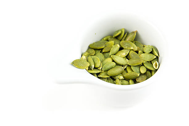 istock seeds of pumpkin on white background 492915956