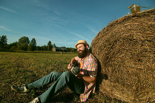 istock man with guitar and beer on the nature 492916924