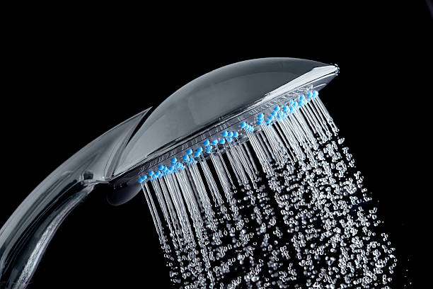 istock Shower with running water over black background 492920392