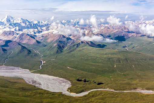 Aerial View of Asian Landscape with Desert Grassy Meadow Steppe River Stream and High Altitude Snowbound Mountains