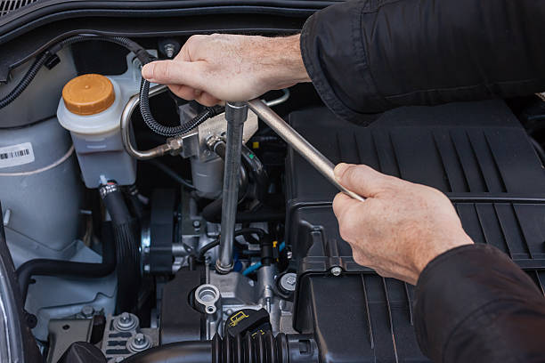 istock Hands repairing a car engine with a wrench 492934166