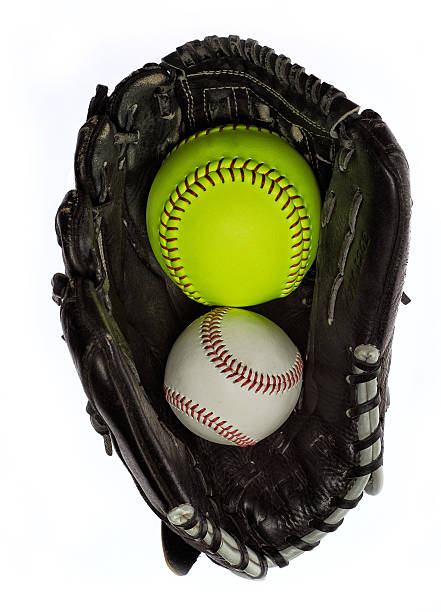 A new fluorescent yellow Softball in a glove against a white background
