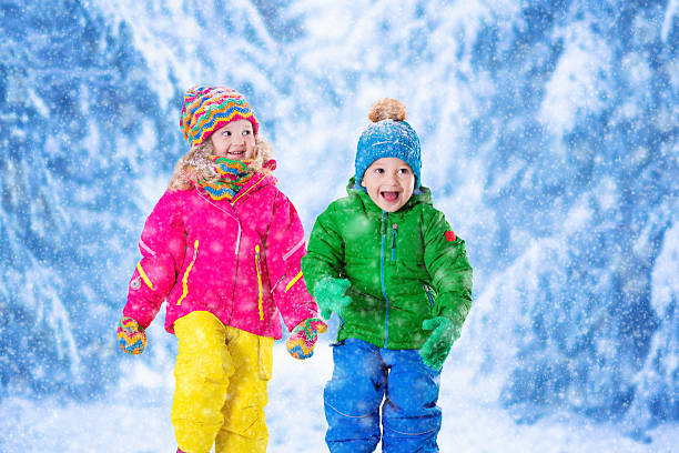 istock Kids playing in snowy winter park 492939024