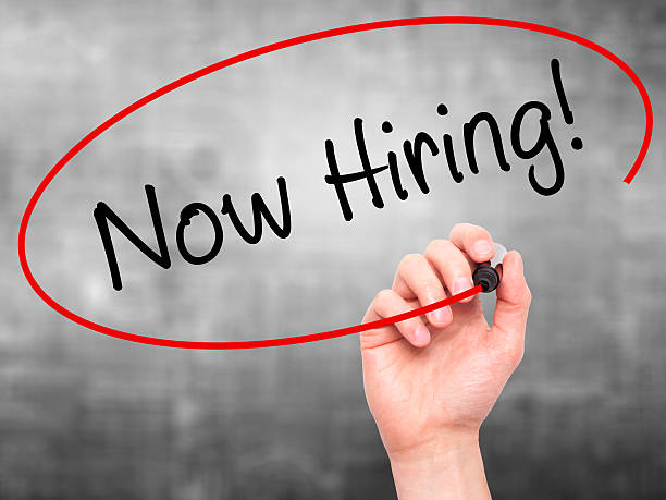 istock Man Hand writing Now Hiring! with marker 492942698