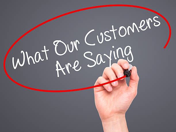 istock Man Hand writing What Our Customers Are Saying with marker 492943064