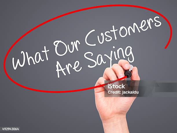 Man Hand Writing What Our Customers Are Saying With Marker Stock Photo - Download Image Now