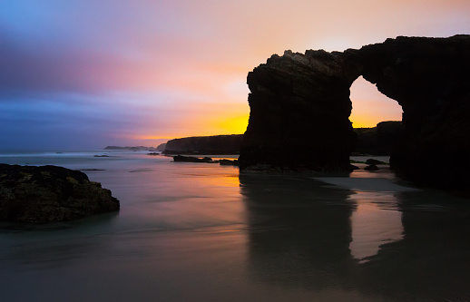 Natural arch at  cantabric coast  of Spain in sunrise time