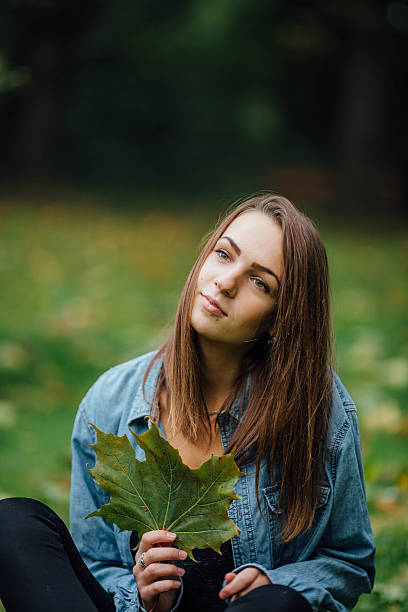 istock Young pretty girl  lying on the grass. 492944032