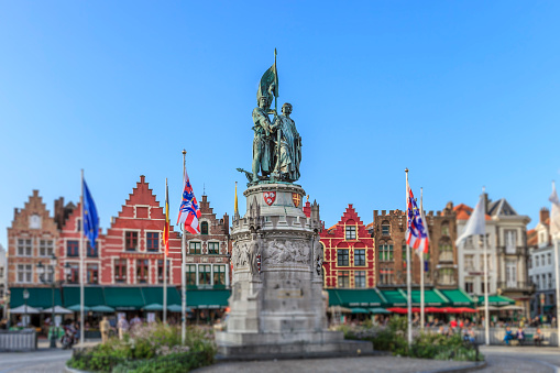 The Grote Markt -Market Square-, in old town of Bruges, is a large square of about 1 hectare lined by notable buildings, such as the Provincial Court and the 13th-century Belfry, one of the landmarks of the city. In the center stands the statue of Jan Breydel and Peter De Coninck, heroes of the Battle of the Golden Spurs of July 1302, built in 1887. Bruges (Brugge in Dutch) is a city of West Flanders in the Flemish Region of Belgium.