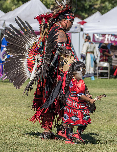 Anderson, California, USA-October 3, 2015: A Native American  father and daughter dancers performs a dance to the drums at the Stillwater Pow-wow in northern California.