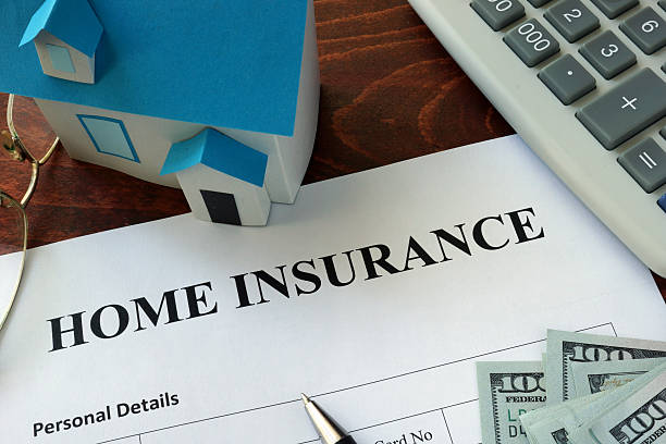 Home insurance form and dollars on the table. stock photo