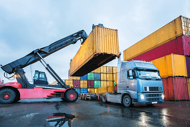 Cargo container transshipment Cargo containers stored in transhipment station large machine stock pictures, royalty-free photos & images