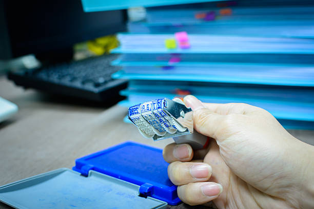 istock Date months years stamper in male's hand on desk 492956672