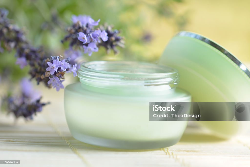 Face moisturizer Face moisturizer with lavender flowers on bamboo background. Shallow dof. 2015 Stock Photo