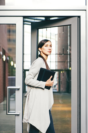 Portrait of successful businesswoman in urban landscape.