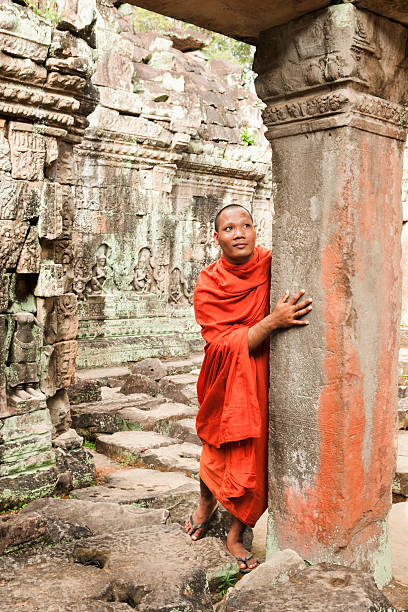 istock Monk wandering through ancient ruins in Cambodia 492960504