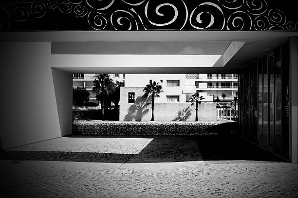 Marina de Lagos, Lagos, Algarve, Portugal - October 15, 2015: Outdoor open space between buildings with a strong noon shadow