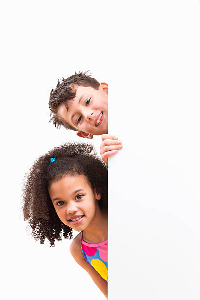 istock Children In Swimsuits Looking Around White Wall At Studio 492962233