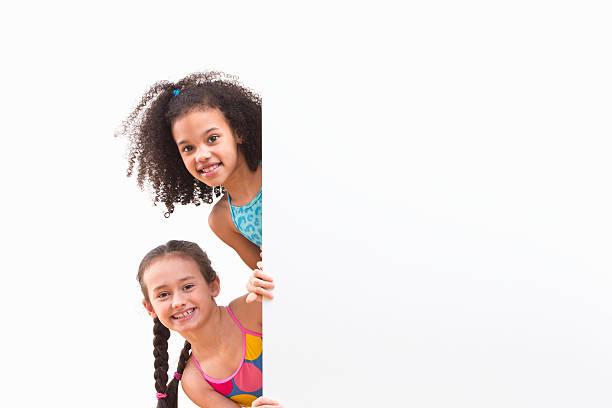 istock Children In Swimsuits Looking Around White Wall At Studio 492962285