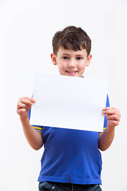 istock Young Boy Holding Blank Sign On White Background 492962303