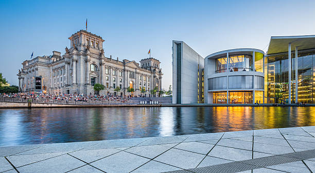 Berlin government district with Reichstag building at dusk Panoramic view of Regierungsviertel (government district) with famous Reichstag building and Paul Lobe Haus (Deutscher Bundestag) at dusk, Berlin, Germany. bundestag stock pictures, royalty-free photos & images