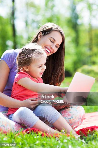 Mother And Daughter Using Laptop Outdoors Stock Photo - Download Image Now - Adult, Cheerful, Child