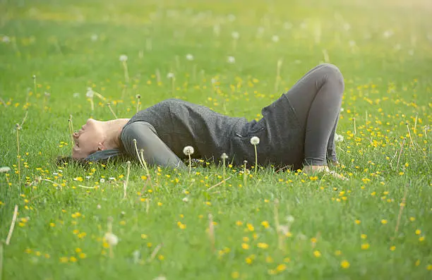 Young woman relax in a summer meadow