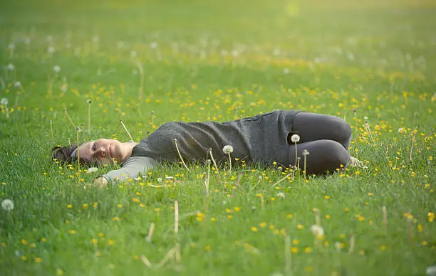 Young woman relax in a summer meadow