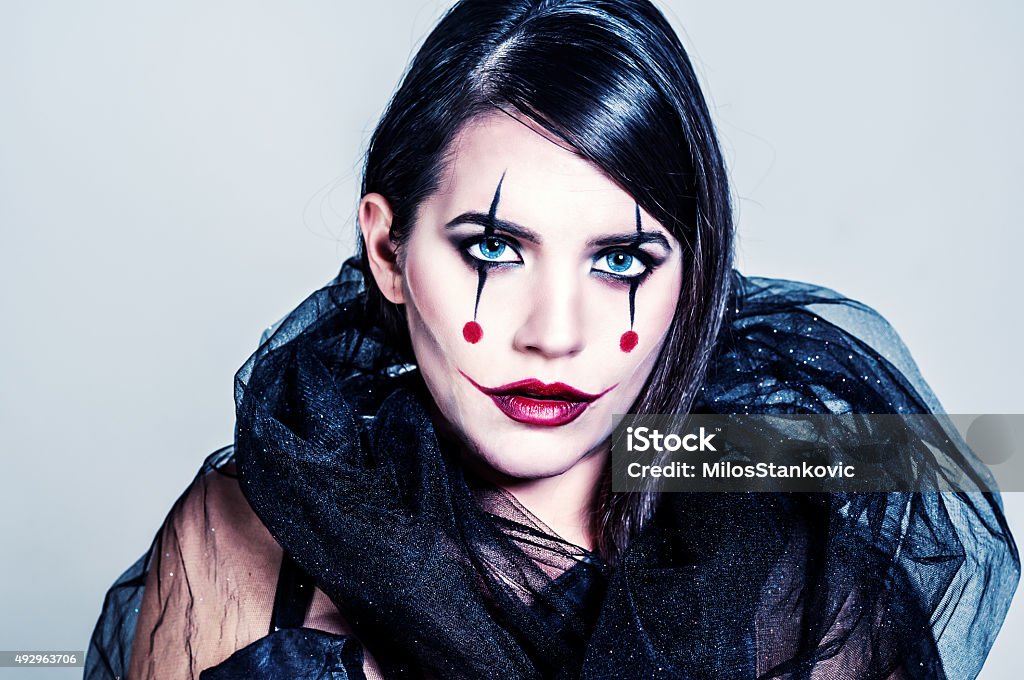 Joker Lady Portrait of young woman with creative make up for halloween . Halloween Stock Photo